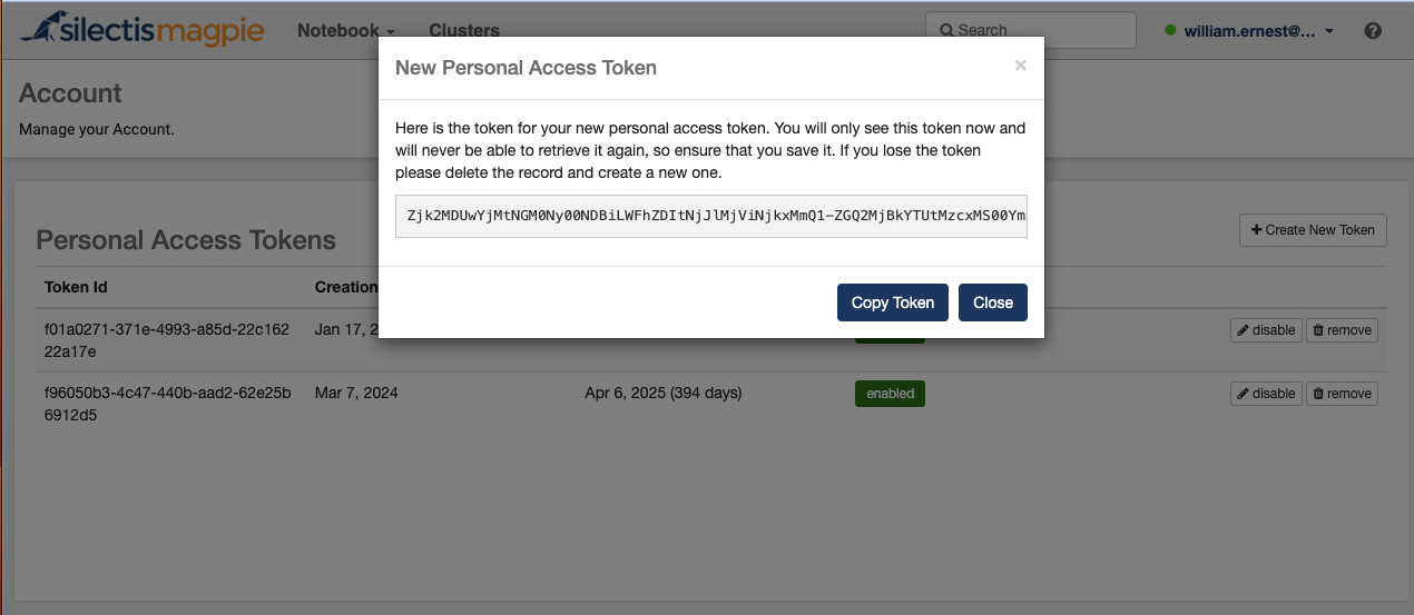A New Personal Access Token dialog showing the generated token once, warning that it cannot be retrieved again, with Copy Token and Close buttons